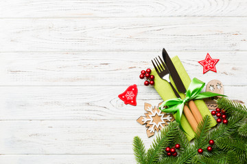 Sticker - Top view of christmas decorations on wooden background. Fork and knife on napkin tied up with ribbon and empty space for your design. New year pattern concept