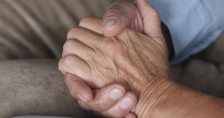 Wall Mural - Senior grandparents couple holding hands, close up view