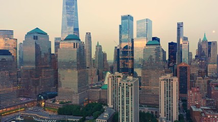 Wall Mural - Drone footage with slow pull back away from New York City Lower Manhattan skyscrapers at dusk