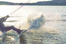 Wakeboard Splashing Water Drops Into The Camera.
