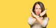 Beautiful middle age woman wearing fashion sweater Rejection expression crossing arms doing negative sign, angry face
