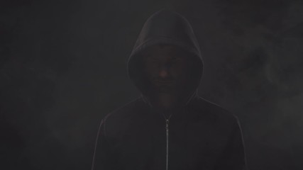 Wall Mural - Portrait of computer hacker in hoodie. Obscured dark face. Data thief, internet fraud, darknet and cyber security .