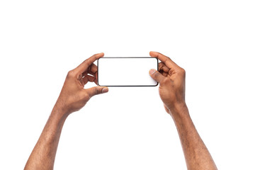 Fototapete - Black male hands taking photo on smartphone with blank screen