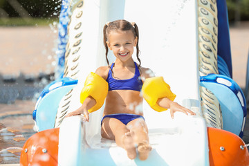 Poster - Little girl having fun in aqua park