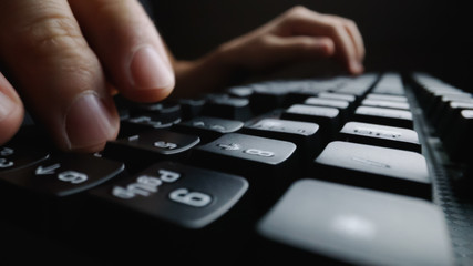 Wall Mural - close-up soft-focus finger typing on keyboard. man hand using laptop computer in office. programming