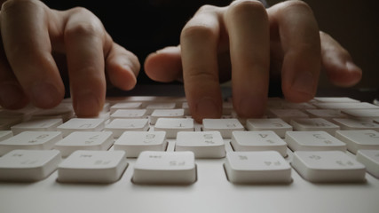 Wall Mural - close-up soft-focus finger typing on keyboard. man hand using laptop computer in office. programming