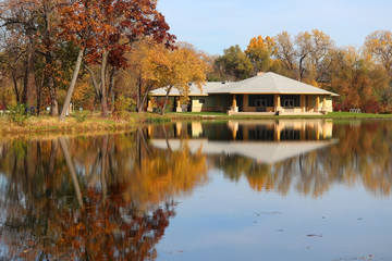 Wall Mural - beautiful autumn midwest nature background. scenic view with colored trees around pavilion in sunlig
