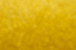 © finepoints - Golden glowing shimmer bokeh background with  blur for elegance rich luxury holiday design.