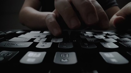 Wall Mural - close-up man typing on computer keyboard with hands and fingers. macro soft focus dolly shot. comput