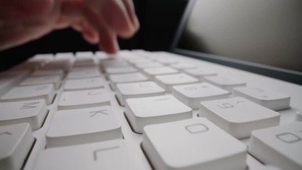 Wall Mural - close-up man typing on computer keyboard with hands and fingers. macro soft focus dolly shot. comput