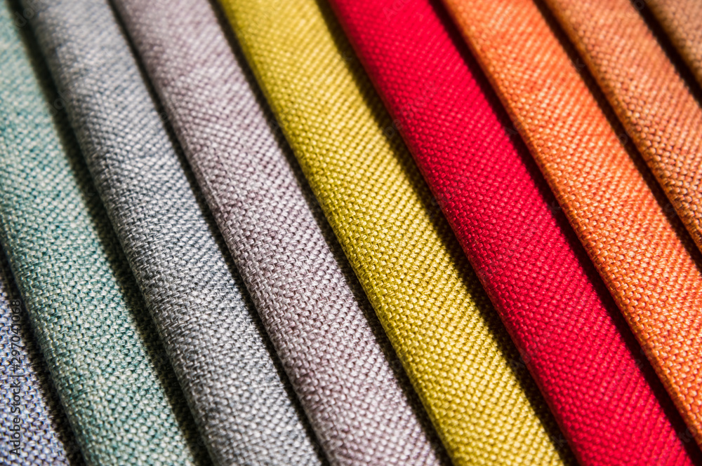 Colorful and bright fabric samples of furniture and clothing upholstery. Close-up of a palette of textile abstract diagonal stripes of different colors - obrazy, fototapety, plakaty 