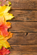 Autumn Composition With Frame Made Of Colourful Leaves On Rustic Wooden Background. Top View