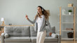© fizkes - Happy energetic young mixed race woman dancing.