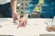 © 88studio - architect engineer working on house blueprint of real estate project. building construction concept.