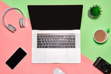 Sticker - Desk table with laptop, coffee cup, headphones and camera on color table