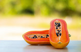Fototapeta  - Healthy papaya, food and fruit placed on a wooden table in the warm natural morning.