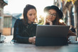 © A_B_C - Friends businesswoman communication using digital tablet together. Girls hipster travels in Barcelona sitting in cafe. Business  friendship concept. Internet laptop technology working process project
