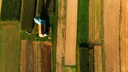 Wall Mural - Lonely Chapel on Farm Fields. Abstract Pattern. Top Down Aerial Drone View