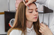 © Асель Иржанова - eyebrow care. Correction of eyebrow tweezers.beautiful young girl beauty salon, perfect eyebrows. Professional care for face.makeup artist applies paint on eyebrows in a beauty