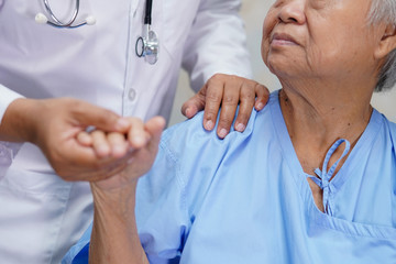 Asian nurse physiotherapist doctor touching Asian senior or elderly old lady woman patient with love, care, helping, encourage and empathy at nursing hospital ward : healthy strong medical concept..