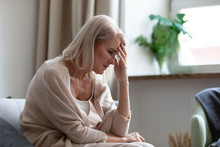 Sad Mature Woman Sitting Alone At Home Feeling Headache Depression