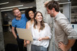 © NDABCREATIVITY - Team of colleagues brainstorming together while working in modern office