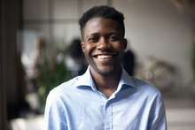 Confident Smiling Young African Businessman Looking At Camera In Office