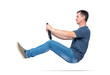© afxhome - Man in jeans and t-shirt drives a car with a steering wheel, isolated on white background. Auto driver concept
