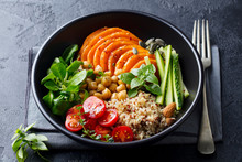 Healthy Vegetarian Salad. Roasted Pumpkin, Quinoa, Tomatoes, Green Salad. Buddha Bowl. Slate Background.