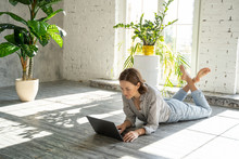 Freelancer Lying With A Laptop On The Floor