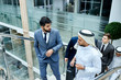 © alfa27 - Caucasian man leads sheikh to discuss business ideas. Business center background