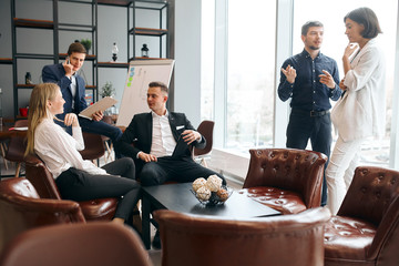 young ambitious people developing marketing plan in the office room with panorama window. lifestyle, job, profession