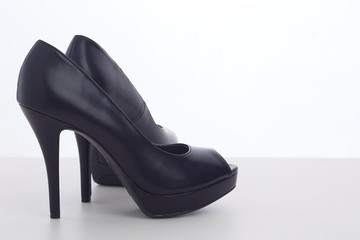 black high-heeled shoes on white