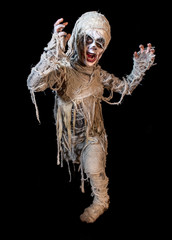 studio shot portrait of young boy in costume dressed as a Halloween, cosplay of scary mummy pose on isolated black background