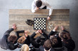 Business people playing chess