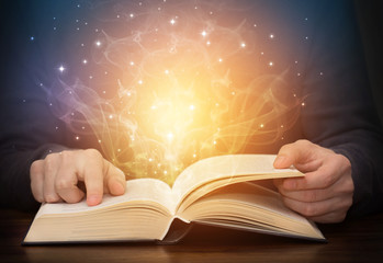 Wall Mural - open magic book with shining light sparkles
