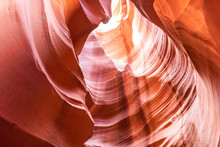 Looking Up Low Angle At Antelope Slot Canyon With Wave Shape Abstract Formations Of Red Orange Rock Layers Sandstone In Page, Arizona