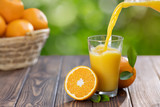 orange juice pouring in glass
