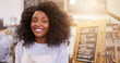 © marvent - Smiling African American entrepreneur barista standing in a bright cafe