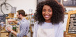 © marvent - Young African American barista smiling while working in a cafe
