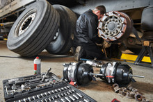 Truck Repair Service. Mechanic Works With Brakes In Truck Workshop