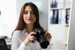 © H_Ko - Smiling businesswoman taking photograph