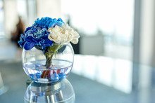 Blue And White Orchids In A Vase On The Table, A Beautiful Arrangement Of Flowers In The Office.