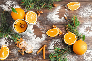 Wall Mural - Christmas composition with fresh oranges and tea on wooden background