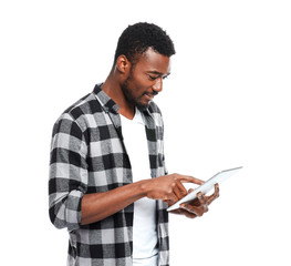Portrait of handsome African-American man with tablet computer on white background