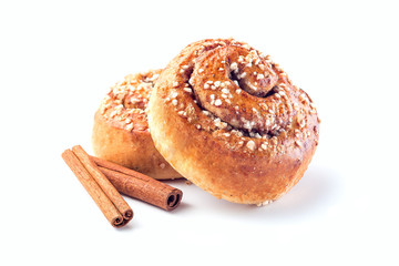 two cinnamon buns and cinnamon sticks isolated on a white background