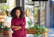 © marvent - Smiling African American woman standing in front of her cafe