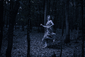 Scared girl running through forest