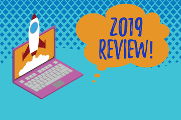 Writing note showing 2019 Review. Business concept for remembering past year events main actions or good shows Rocket launching clouds laptop background. Startup project growing. SEO