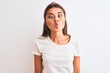 © Krakenimages.com - Young beautiful woman wearing casual t-shirt and diadem over isolated white background making fish face with lips, crazy and comical gesture. Funny expression.